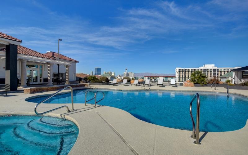 a swimming pool with buildings in the background