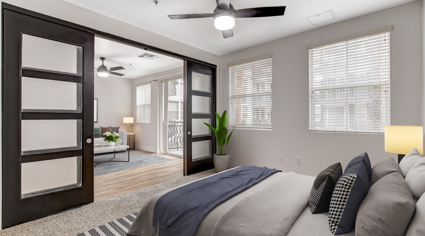 bedroom with bed and lamp and windows