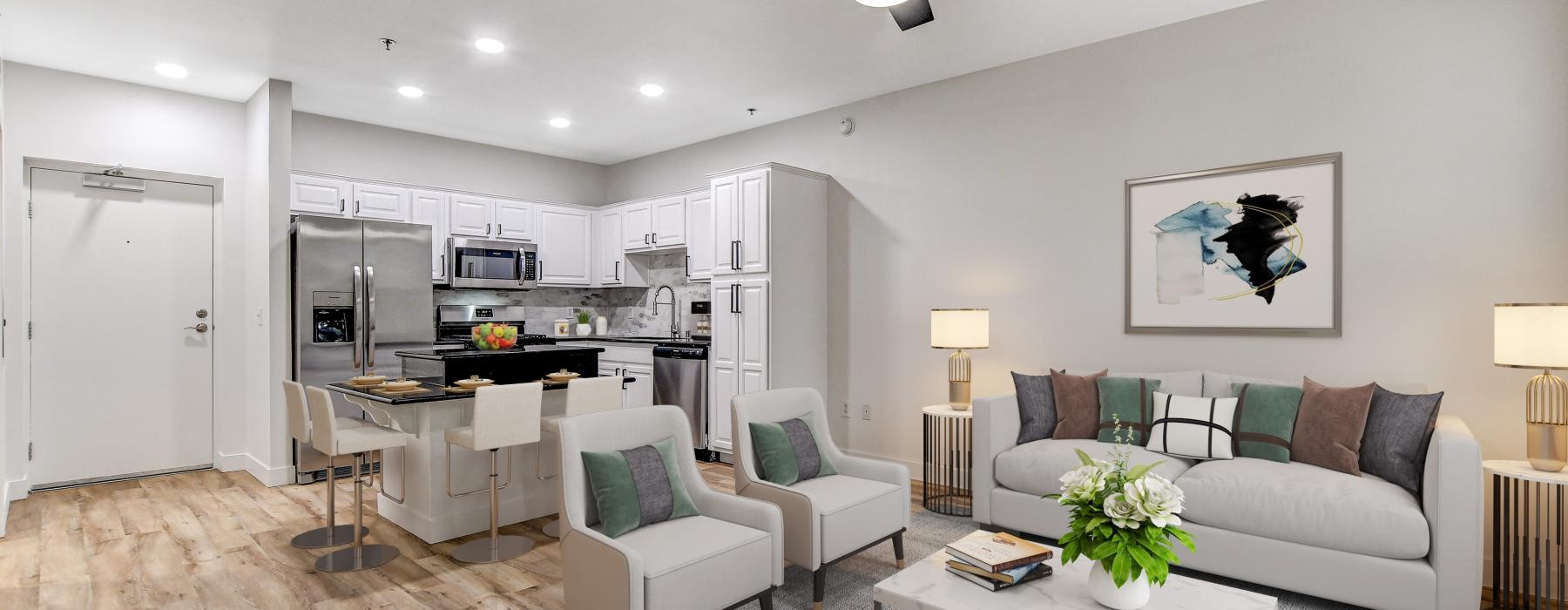 a living room with a seating table and view of a kitchen