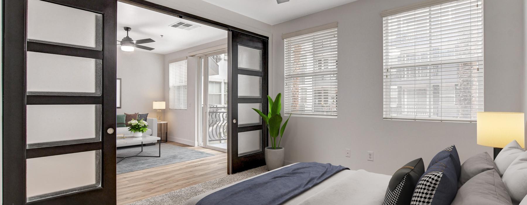 a living room with a bed and a fan